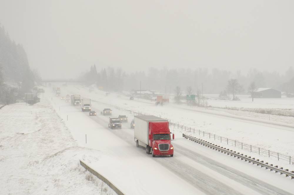 semi truck driving in snow